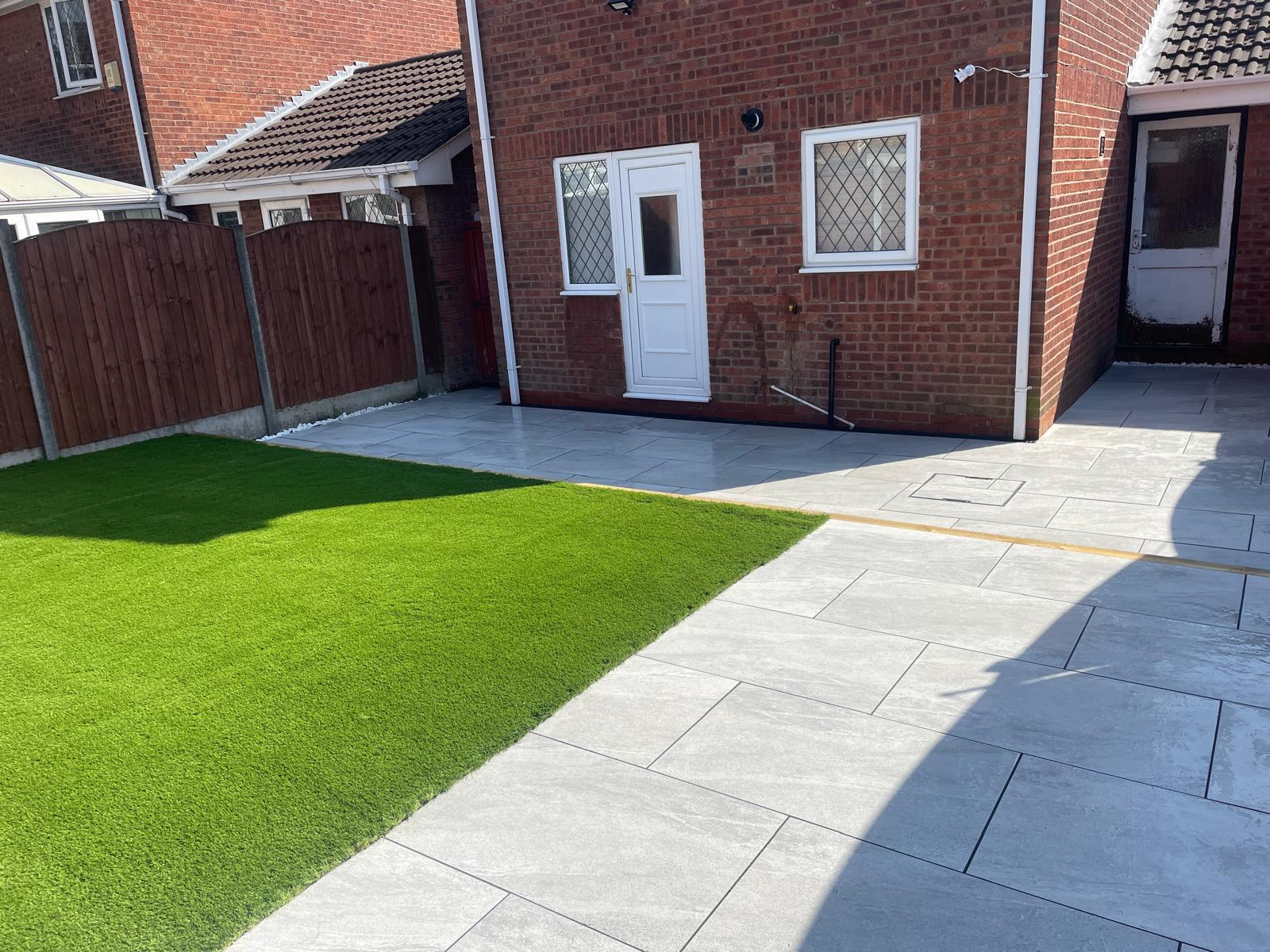 Stone effect porcelain patio with artificial grass garden redesign, Warrington