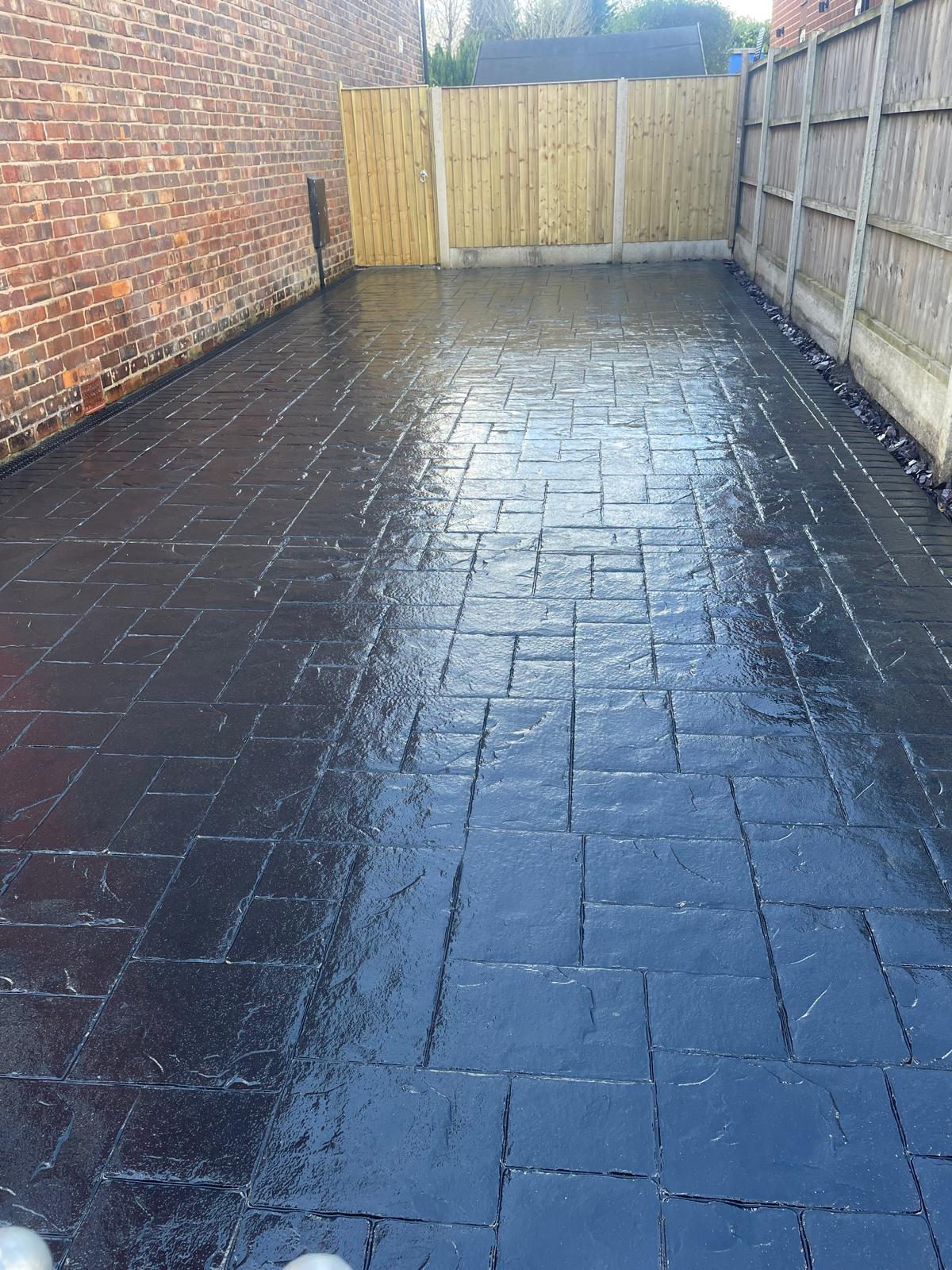 Long charcoal imprinted concrete driveway with dual-tone feature design, Warrington